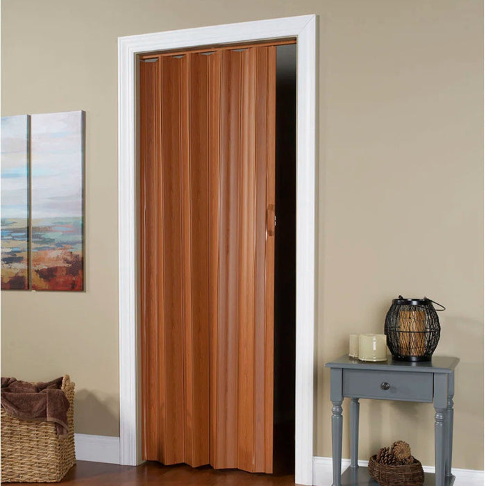 Wooden folding door in a room with a side table and decor items.